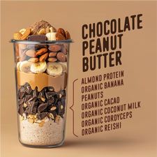Chocolate Peanut Butter ingredients list displayed alongside a layered smoothie glass. The glass contains almonds, chocolate pieces, banana slices, peanuts, and layers of peanut butter, chocolate, and almond protein. The listed ingredients include almond protein, organic banana, peanuts, organic cacao, organic coconut milk, organic cordyceps, and organic reishi.