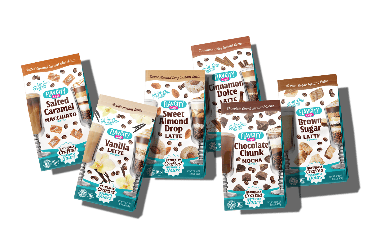 Seven packets of Flavor City instant latte mixes, including Salted Caramel, Vanilla, Sweet Almond Drop, Chocolate Chunk, Cinnamon Dolce, and Brown Sugar flavors, arranged overlapping on a white background.