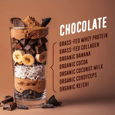 A glass layered with banana slices, shredded coconut, chocolate chunks, and cocoa powder sits beside Shop FlavCity’s Protein Smoothie Starter Kit single-serve meal packets and a list of chocolate smoothie ingredients on a brown background.