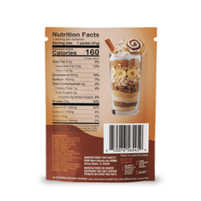Back of a Shop FlavCity Protein Smoothie Single-Serve Cinnamon Roll packet with nutrition facts, ingredients, and barcode; above is a glass dessert layered with whipped cream, banana slices, wafers, and a rolled wafer garnish.