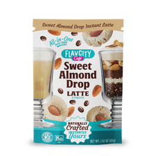 Front of a FlavCity Cafe Latte Variety Pack shows latte glasses, almonds, coffee beans, and cookies. Text highlights “All-in-One, Just Add Water!”—offering indulgent single-serve lattes in the FlavCity Cafe Latte Variety Pack.
