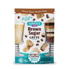 A packet from the FlavCity Cafe Latte Variety Pack features images of lattes, brown sugar cubes, coffee beans, and parfaits, with packaging that states “All-in-One, Just Add Water!” and “Naturally Crafted Instantly Yours.”.